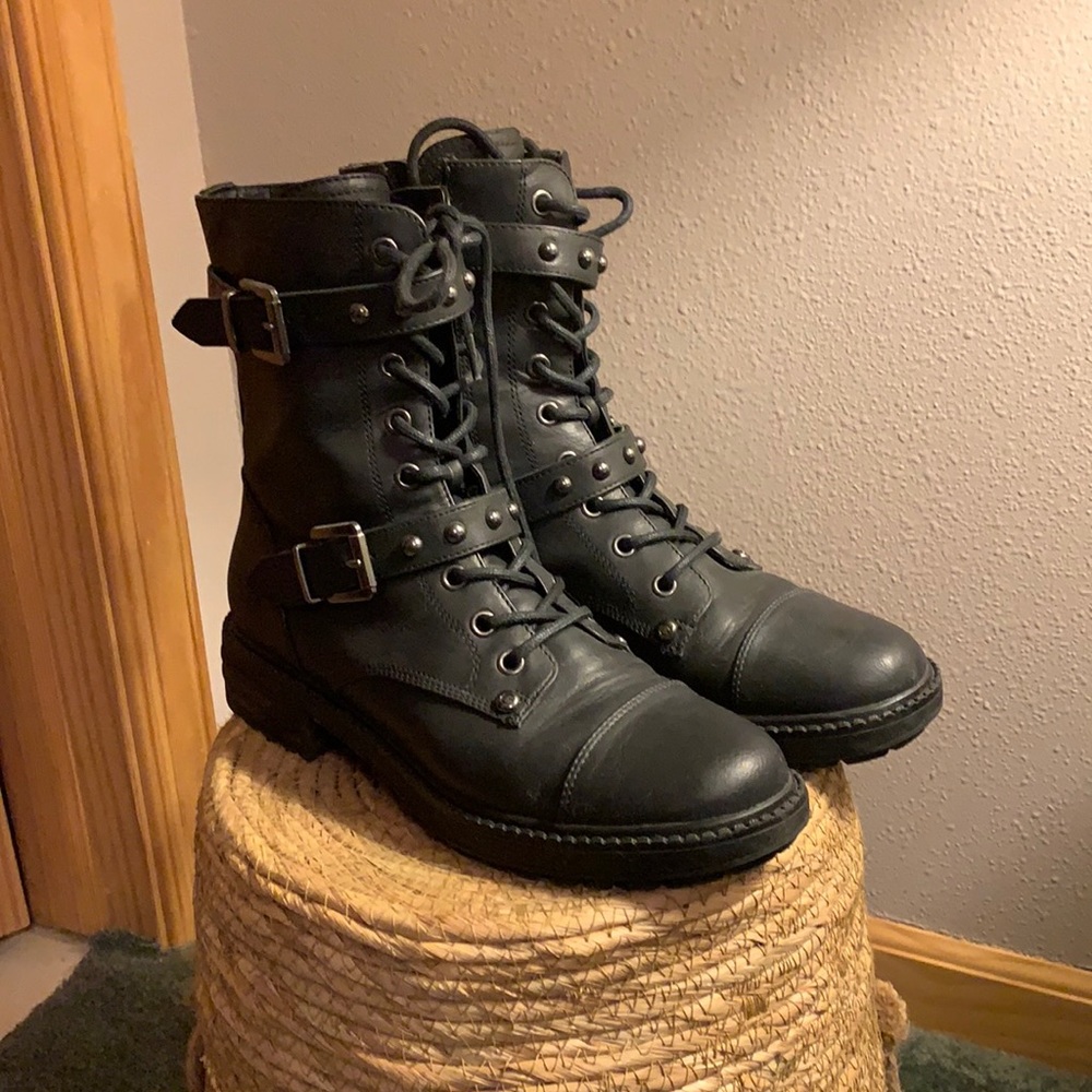 Black combat style boots with inner side zipper.